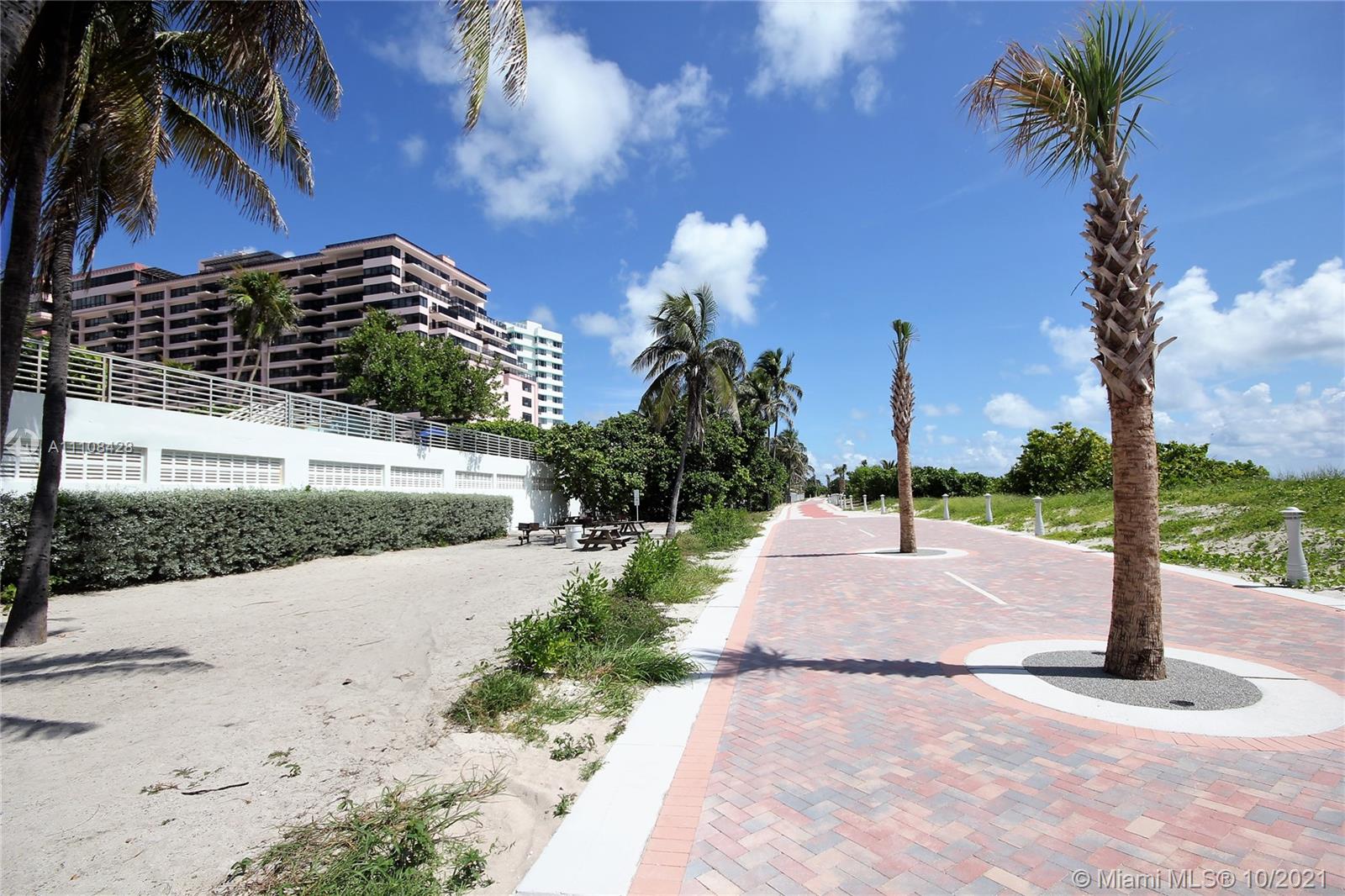 5161 Collins Avenue, Unit 711 Miami Beach, FL 33140 - Photo 48 of 67 a sidewalk with a building and trees in the background