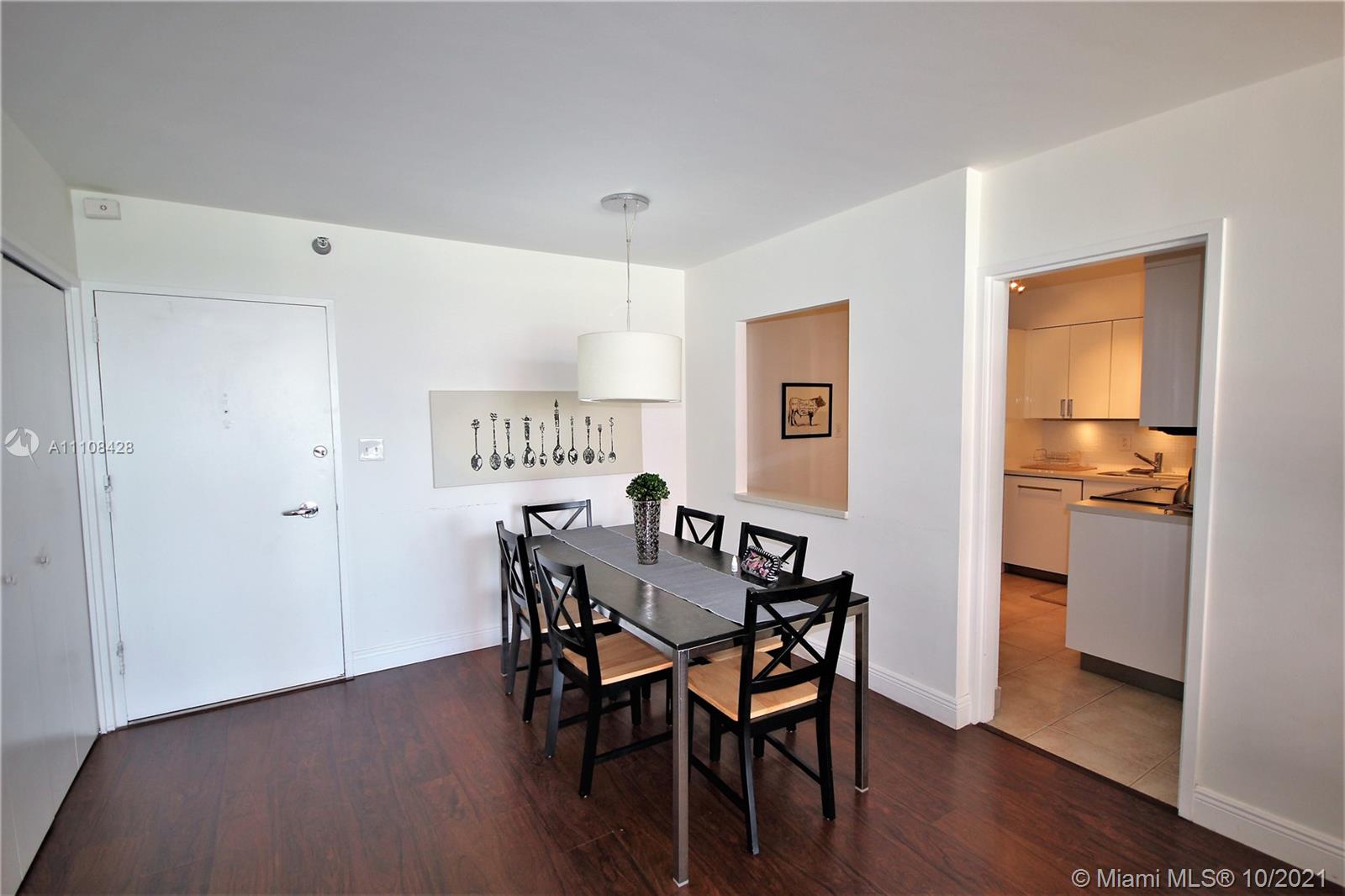 5161 Collins Avenue, Unit 711 Miami Beach, FL 33140 - Photo 7 of 67 a view of a dining room with furniture and wooden floor