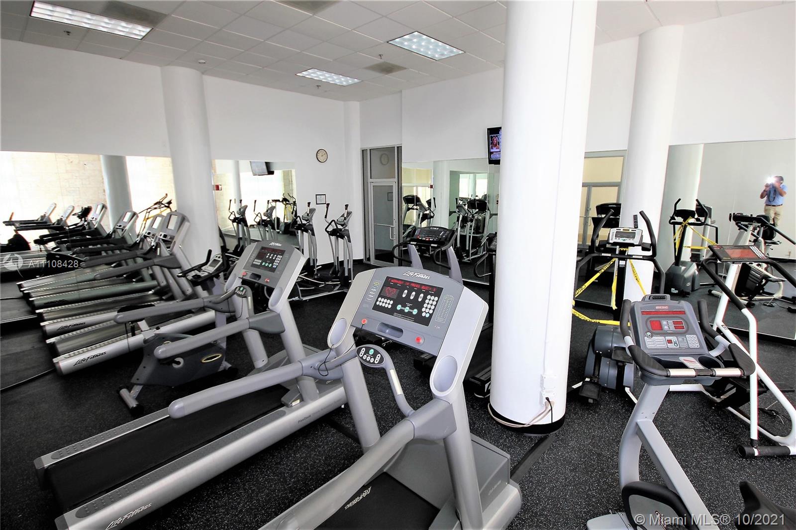 5161 Collins Avenue, Unit 711 Miami Beach, FL 33140 - Photo 64 of 67 a view of a room with gym equipment