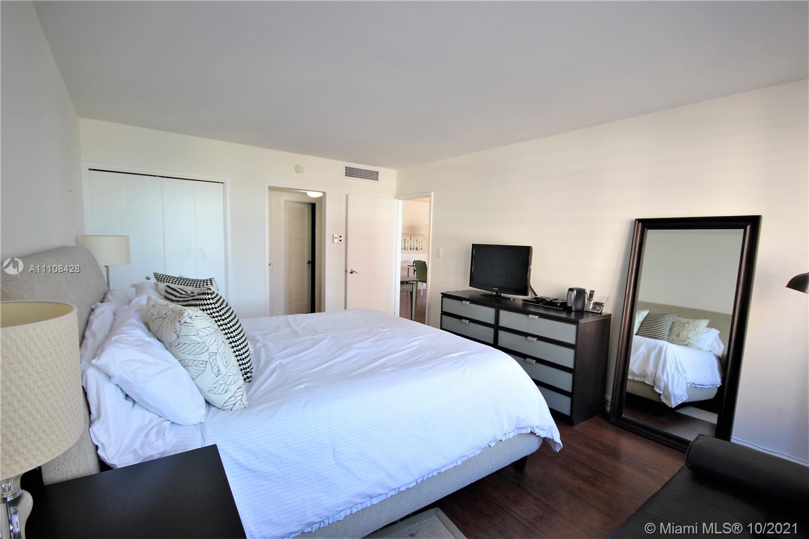 5161 Collins Avenue, Unit 711 Miami Beach, FL 33140 - Photo 10 of 67 a bedroom with a bed and a television