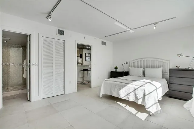 a bedroom with a bed and a walk in closet