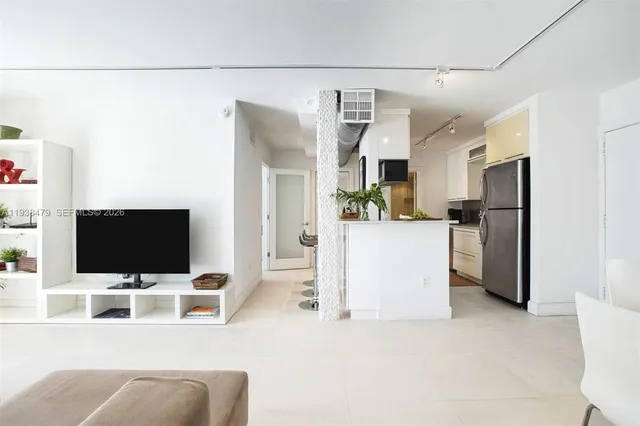 a room with a faucet a potted plant and white countertops