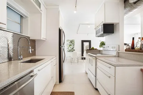 a kitchen with a sink stove and refrigerator