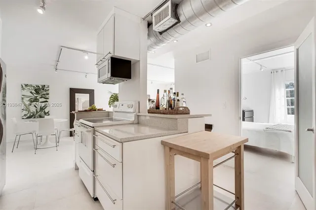 a kitchen with stainless steel appliances a sink and a refrigerator