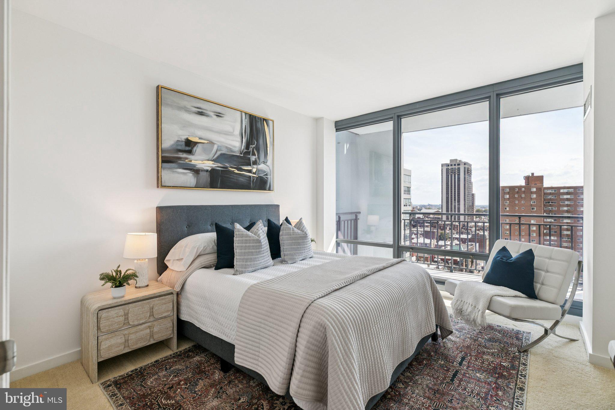 2101 Market Street, Unit 905 Philadelphia, PA 19103 - Photo 12 of 30 a bedroom with a large bed and a balcony