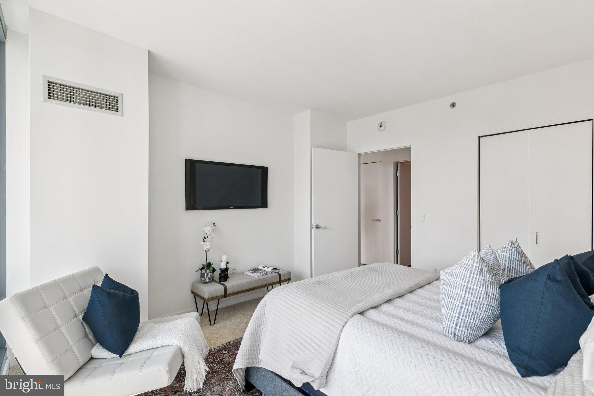 2101 Market Street, Unit 905 Philadelphia, PA 19103 - Photo 14 of 30 a bedroom with a bed and a flat screen tv