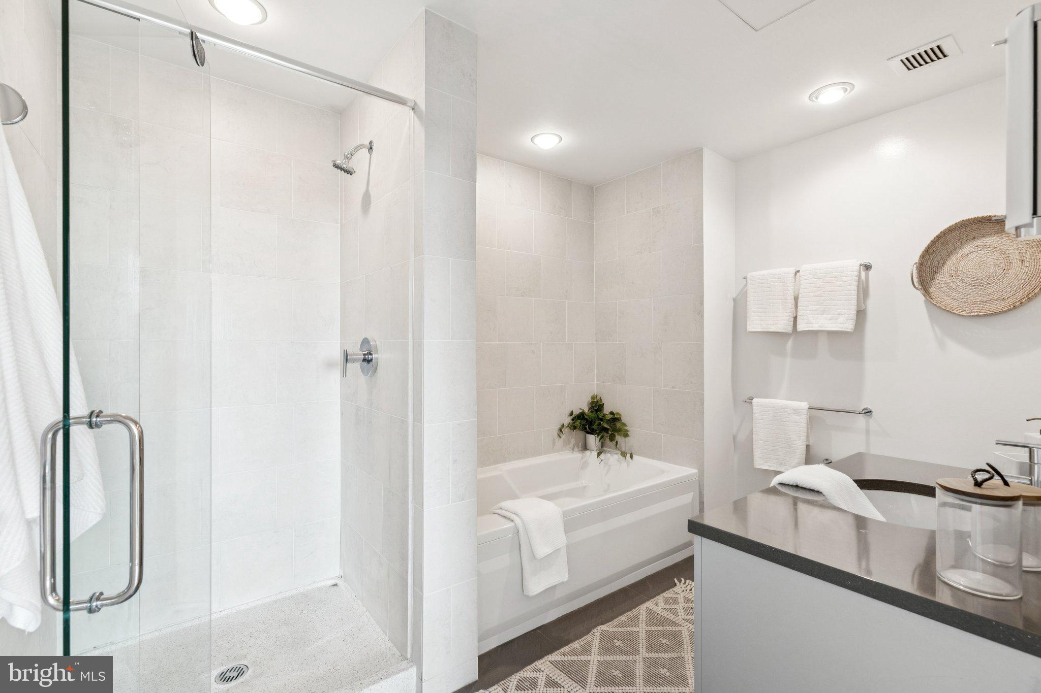 2101 Market Street, Unit 905 Philadelphia, PA 19103 - Photo 18 of 30 a bathroom with a sink a toilet and shower
