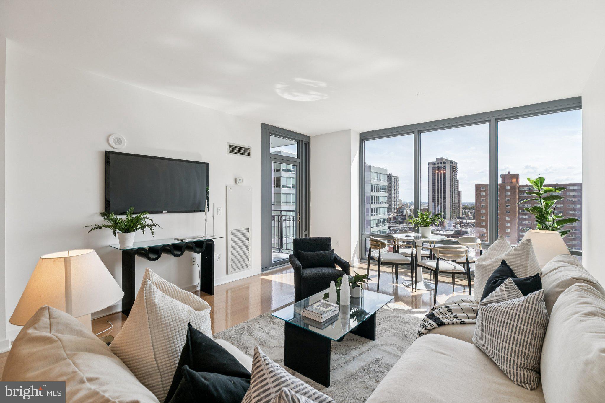 2101 Market Street, Unit 905 Philadelphia, PA 19103 - Photo 3 of 30 a living room with furniture and a flat screen tv