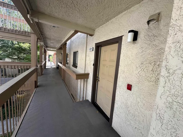 a view of a hallway with windows