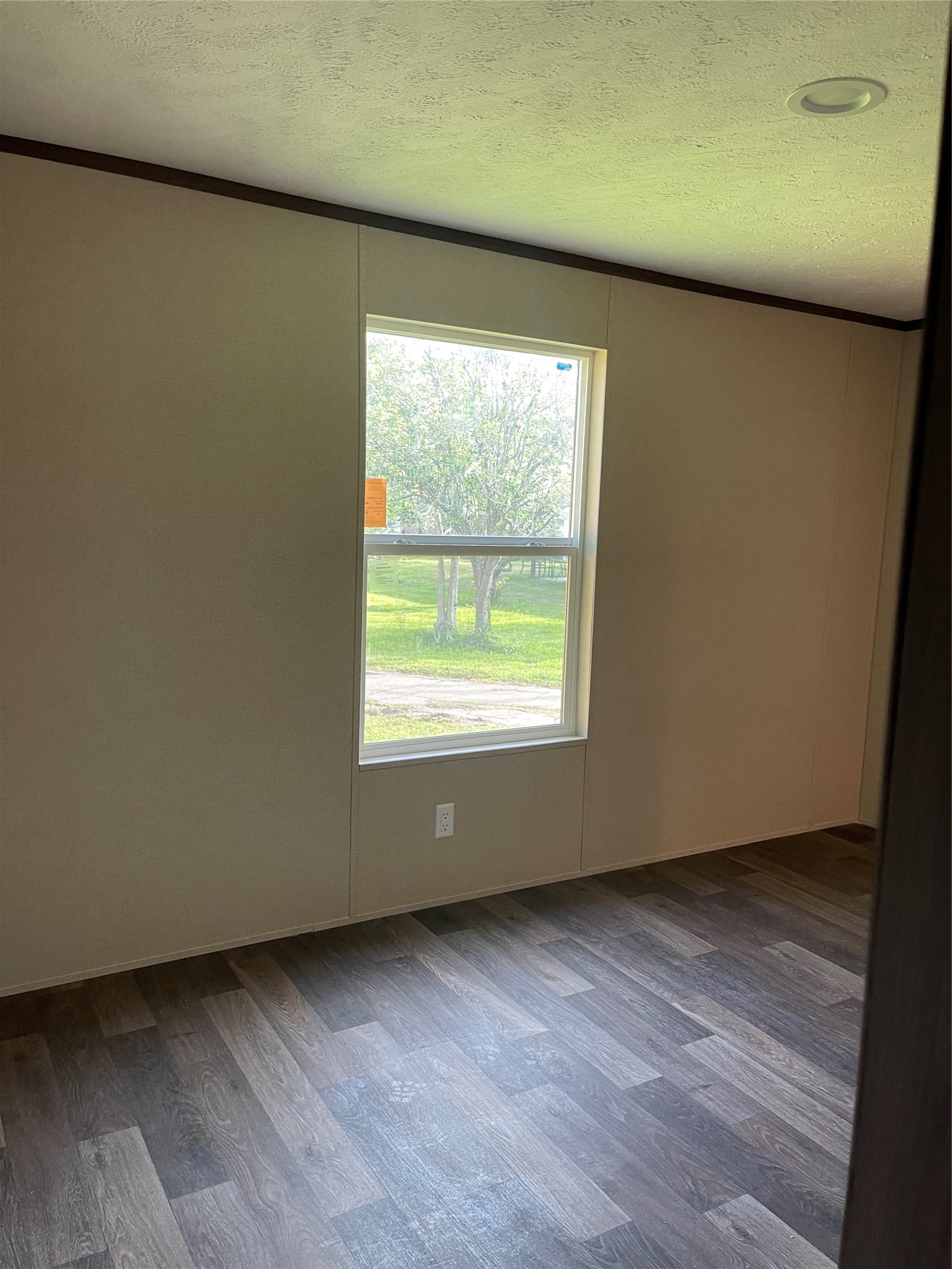 8114 McHard Road Pearland, TX 77581 - Photo 2 of 12 This family area features a large window allowing natural light, neutral walls, and wood-look flooring, creating a cozy and bright space.