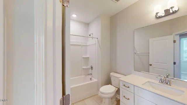 a spacious bathroom with a double vanity sink a mirror and a shower
