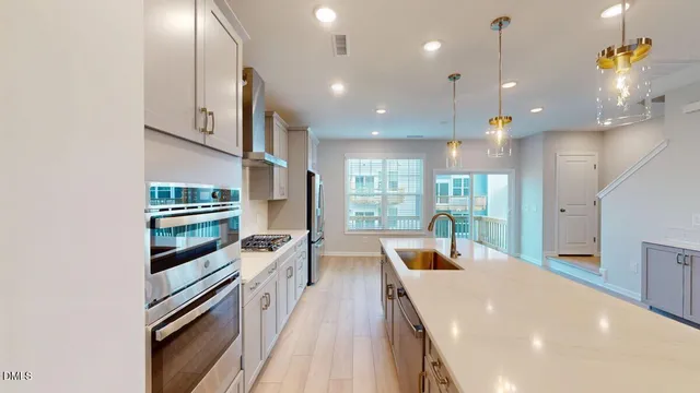 a kitchen with a refrigerator and a stove top oven