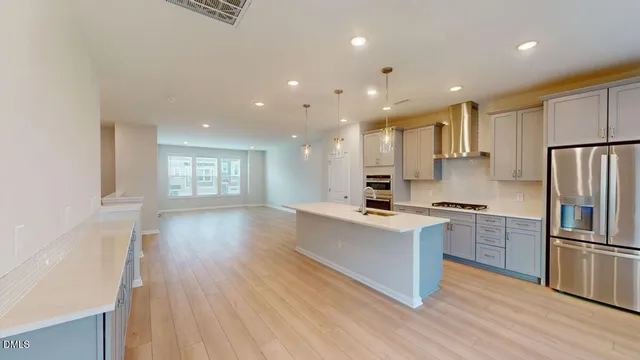 a view of a big room with wooden floor and windows