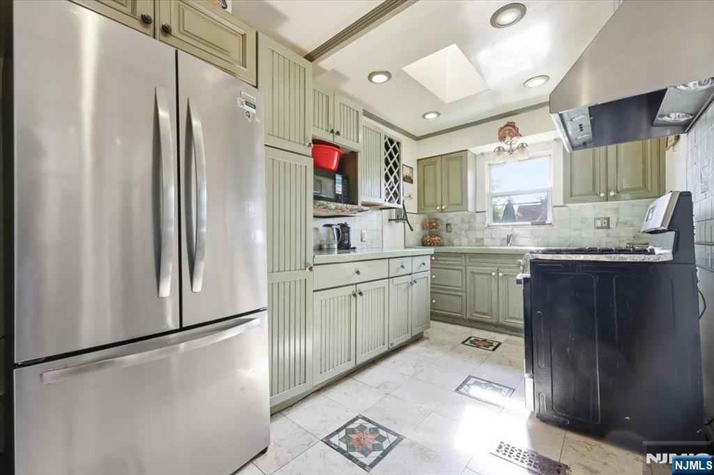 409 Tryon Avenue Englewood, NJ 07631 - Photo 9 of 33 a kitchen with a sink appliances and cabinets