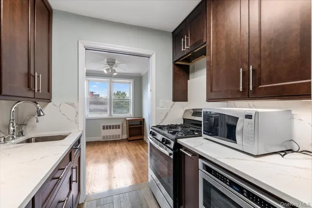 a kitchen with a sink stove and refrigerator