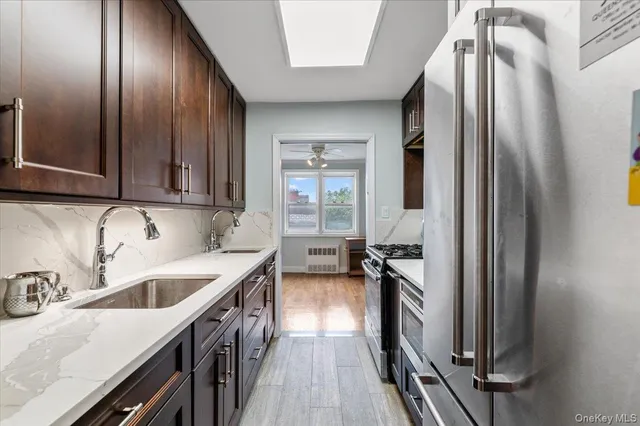 a kitchen with sink stove and cabinets
