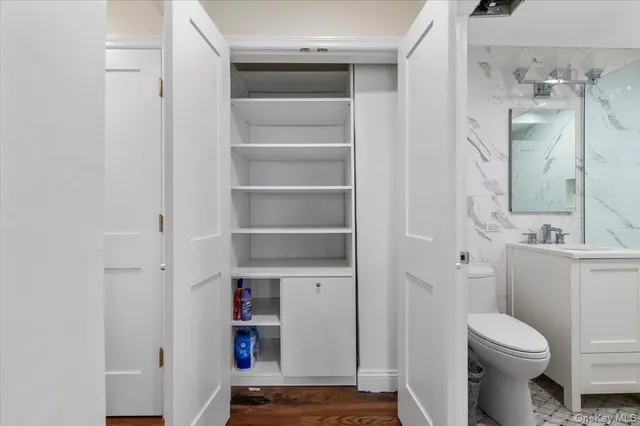 a bathroom with a toilet sink and shower