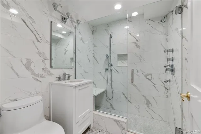 a living room with a bed furniture and a flat screen tv