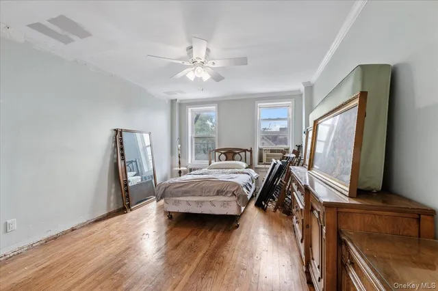 a bedroom with a large bed and a flat tv screen on dresser