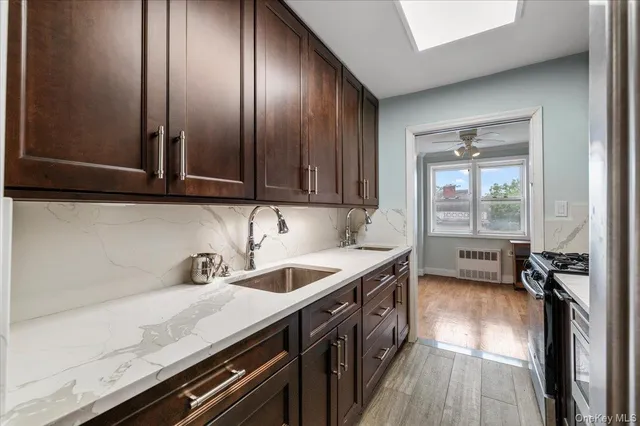 a kitchen with a stove sink and cabinets