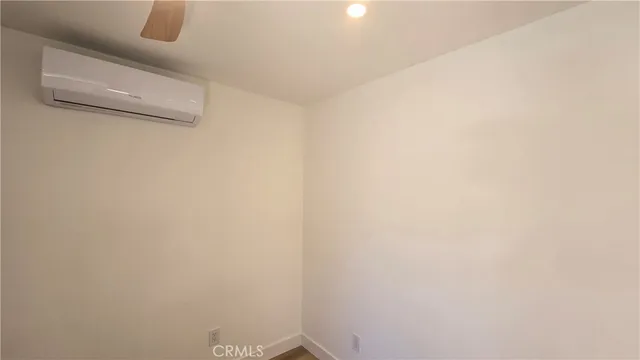 a view of hallway with bathroom and wooden floor