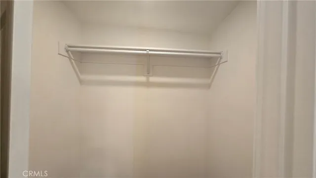 a view of a room with wooden floor and a ceiling fan