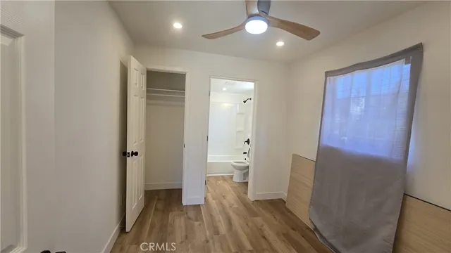 a bathroom with a sink a mirror a window and a shower