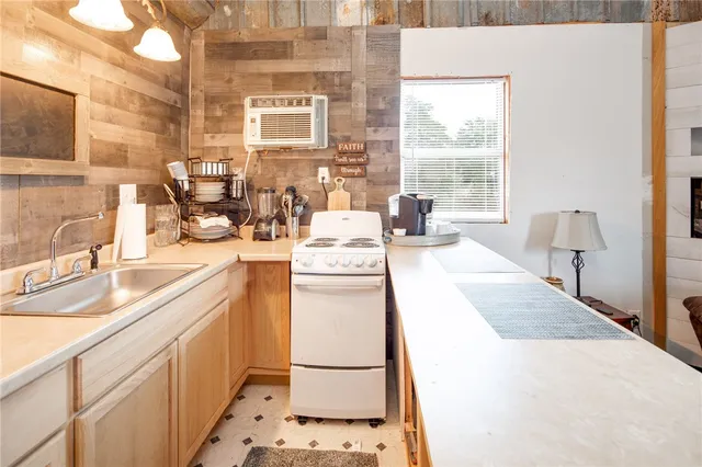 a kitchen with a sink a refrigerator and a stove