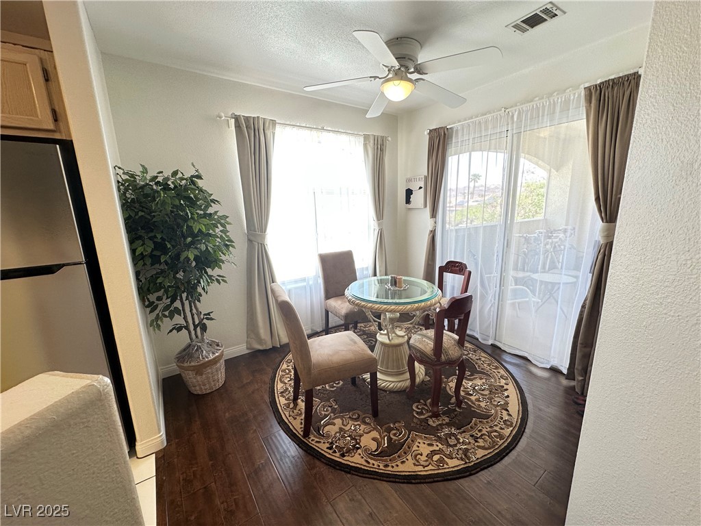 698 South Racetrack Road, Unit 322 Henderson, NV 89015 - Photo 11 of 39 Dining space with visible vents, a ceiling fan, baseboards, and wood finished floors