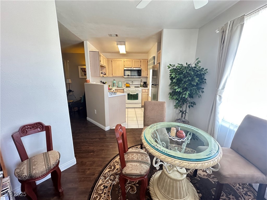 698 South Racetrack Road, Unit 322 Henderson, NV 89015 - Photo 12 of 39 Dining area with plenty of natural light, a ceiling fan, wood finished floors, and visible vents