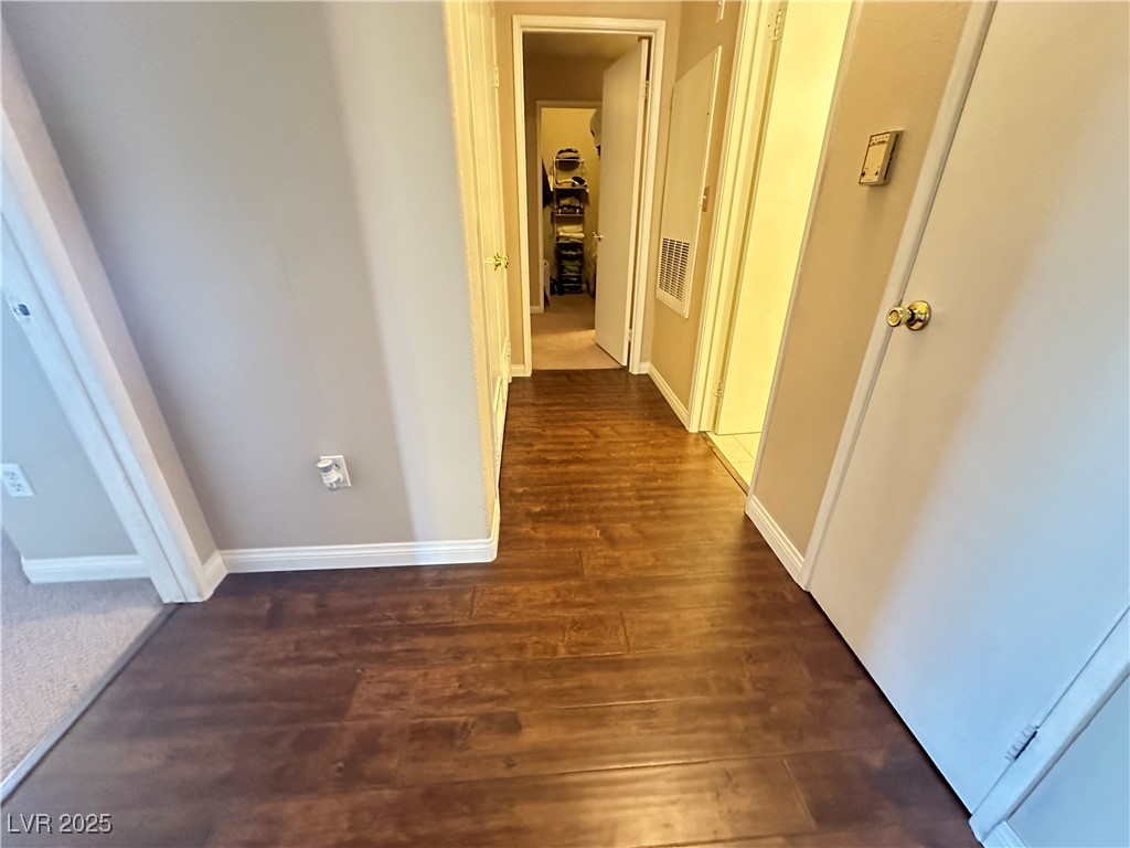 698 South Racetrack Road, Unit 322 Henderson, NV 89015 - Photo 19 of 39 Corridor featuring baseboards, dark wood finished floors, and visible vents