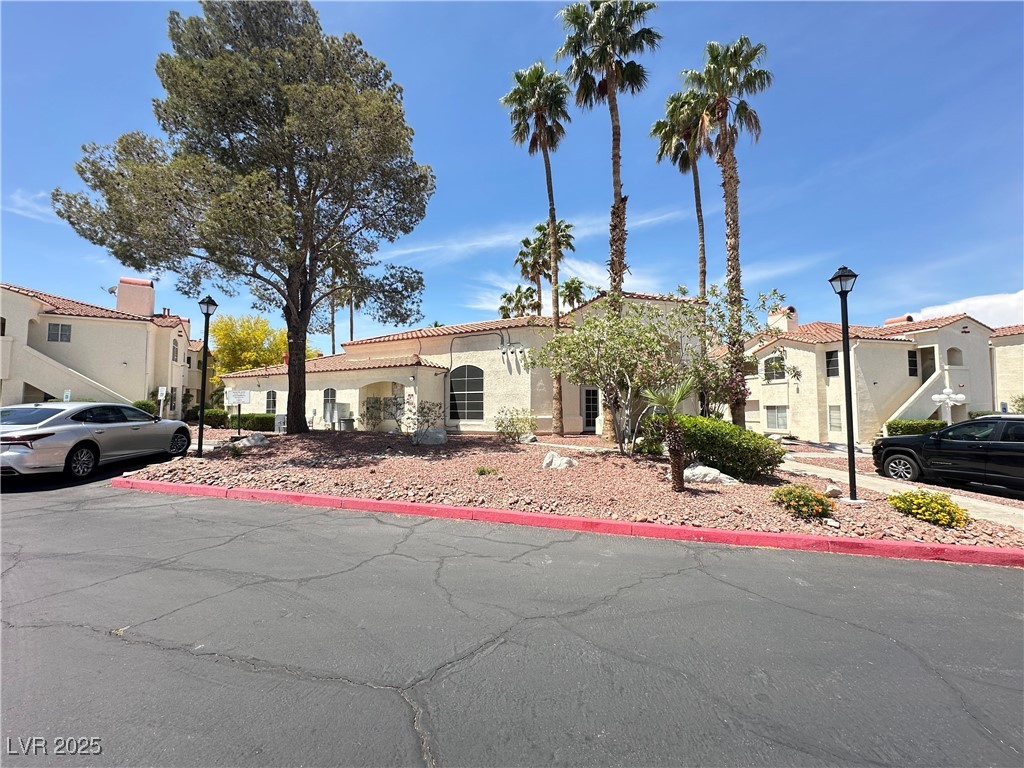 698 South Racetrack Road, Unit 322 Henderson, NV 89015 - Photo 2 of 39 Mediterranean / spanish home featuring a residential view, stucco siding, and a tiled roof