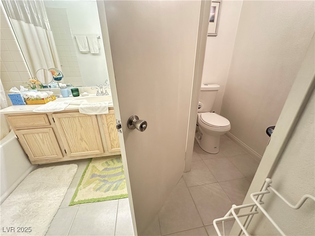 698 South Racetrack Road, Unit 322 Henderson, NV 89015 - Photo 26 of 39 Full bath with toilet, a shower with shower curtain, tile patterned flooring, and vanity