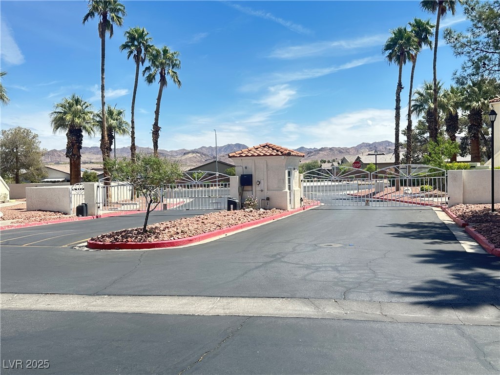 698 South Racetrack Road, Unit 322 Henderson, NV 89015 - Photo 3 of 39 View of road with a gate, a mountain view, and curbs