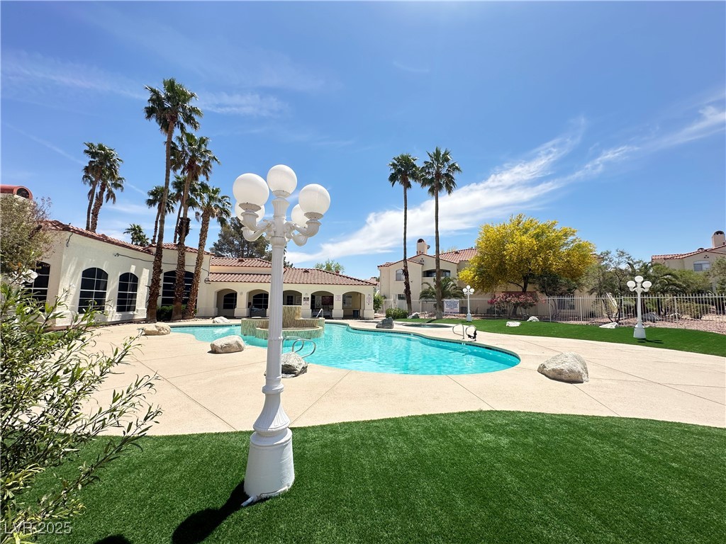 698 South Racetrack Road, Unit 322 Henderson, NV 89015 - Photo 38 of 39 View of pool featuring a lawn, fence, a fenced in pool, and a patio area