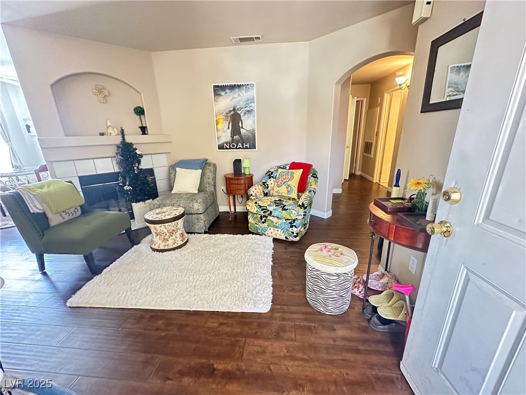 698 South Racetrack Road, Unit 322 Henderson, NV 89015 - Photo 5 of 39 Living area featuring arched walkways, baseboards, wood finished floors, and visible vents