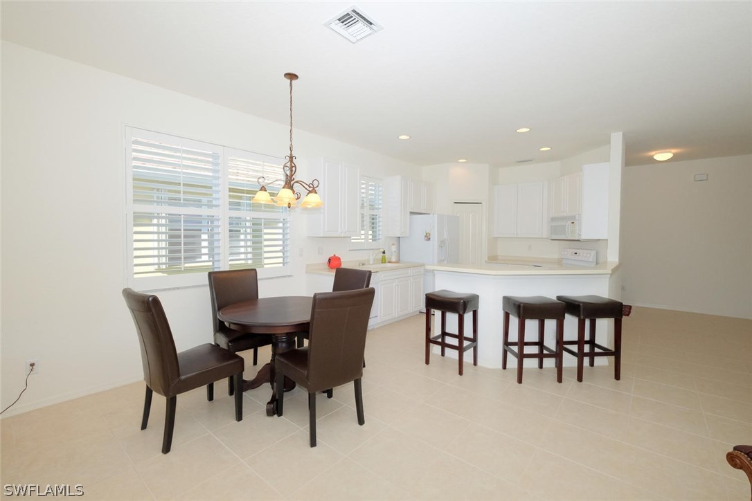 4717 Fairloop Run Lehigh Acres, FL 33973 - Photo 4 of 20 a dining room with furniture and window