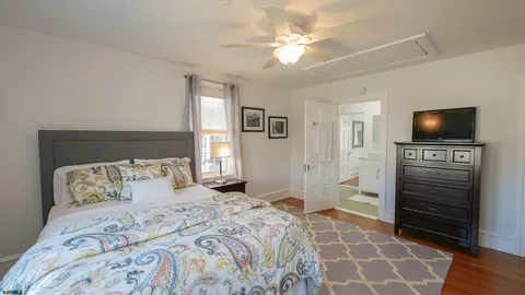 a bedroom with a bed and a television