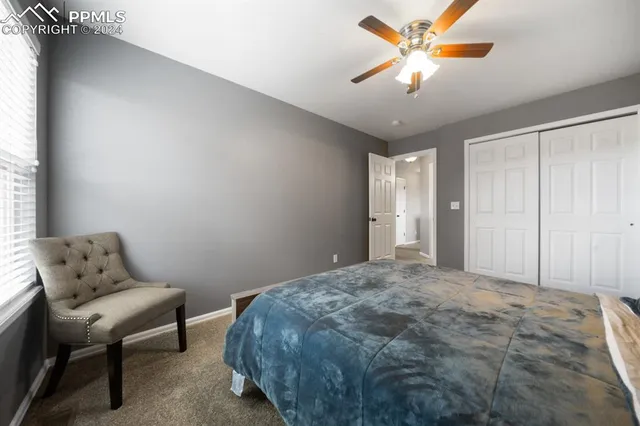 a bedroom with a bed and a couch