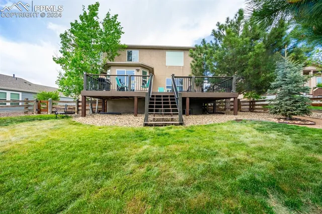 a view of a house with a yard and sitting area