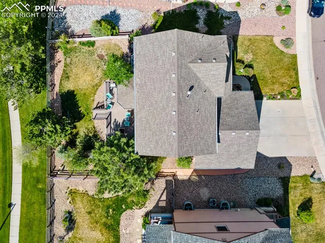 an aerial view of a house with a yard