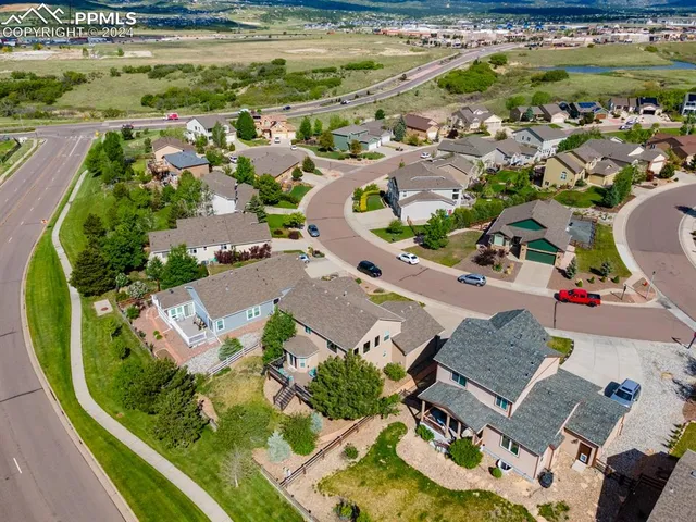 an aerial view of residential houses with outdoor space