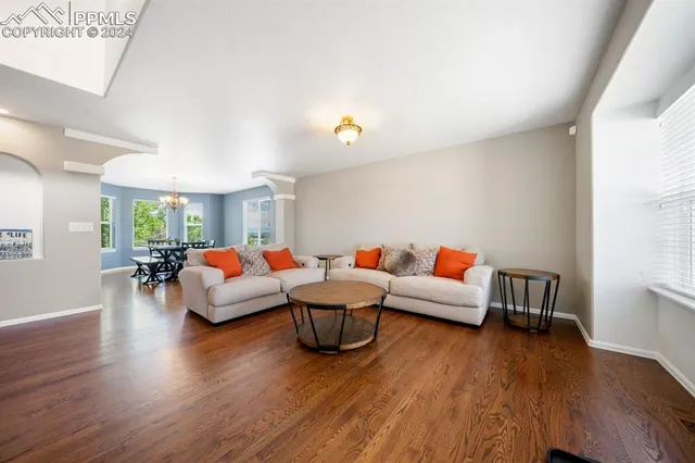 a living room with fireplace furniture and a wooden floor