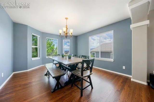 a view of a dining room with furniture window and wooden floor