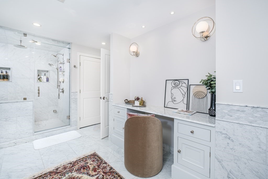 59 Crestview Road Milton, MA 02186 - Photo 20 of 42 a spacious bathroom with a granite countertop sink a mirror a vanity and shower