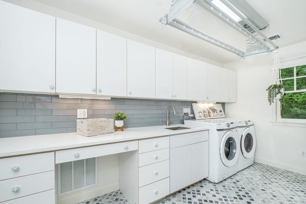 59 Crestview Road Milton, MA 02186 - Photo 26 of 42 a view of a storage and utility room with washer and dryer