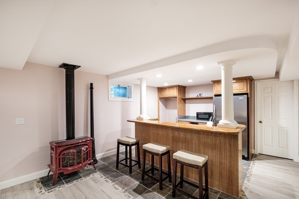 59 Crestview Road Milton, MA 02186 - Photo 30 of 42 a kitchen with kitchen island a stove a table and chairs in it