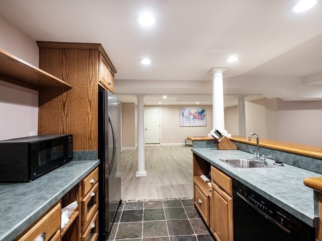 59 Crestview Road Milton, MA 02186 - Photo 32 of 42 a kitchen with granite countertop a sink and a stove