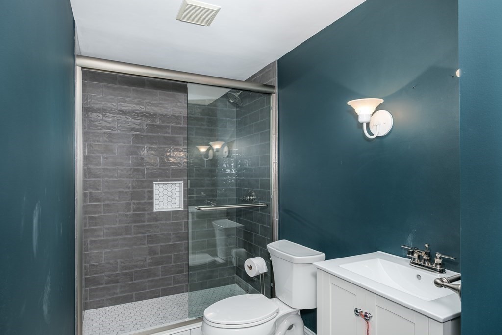 59 Crestview Road Milton, MA 02186 - Photo 33 of 42 a white toilet sitting next to a bathroom sink