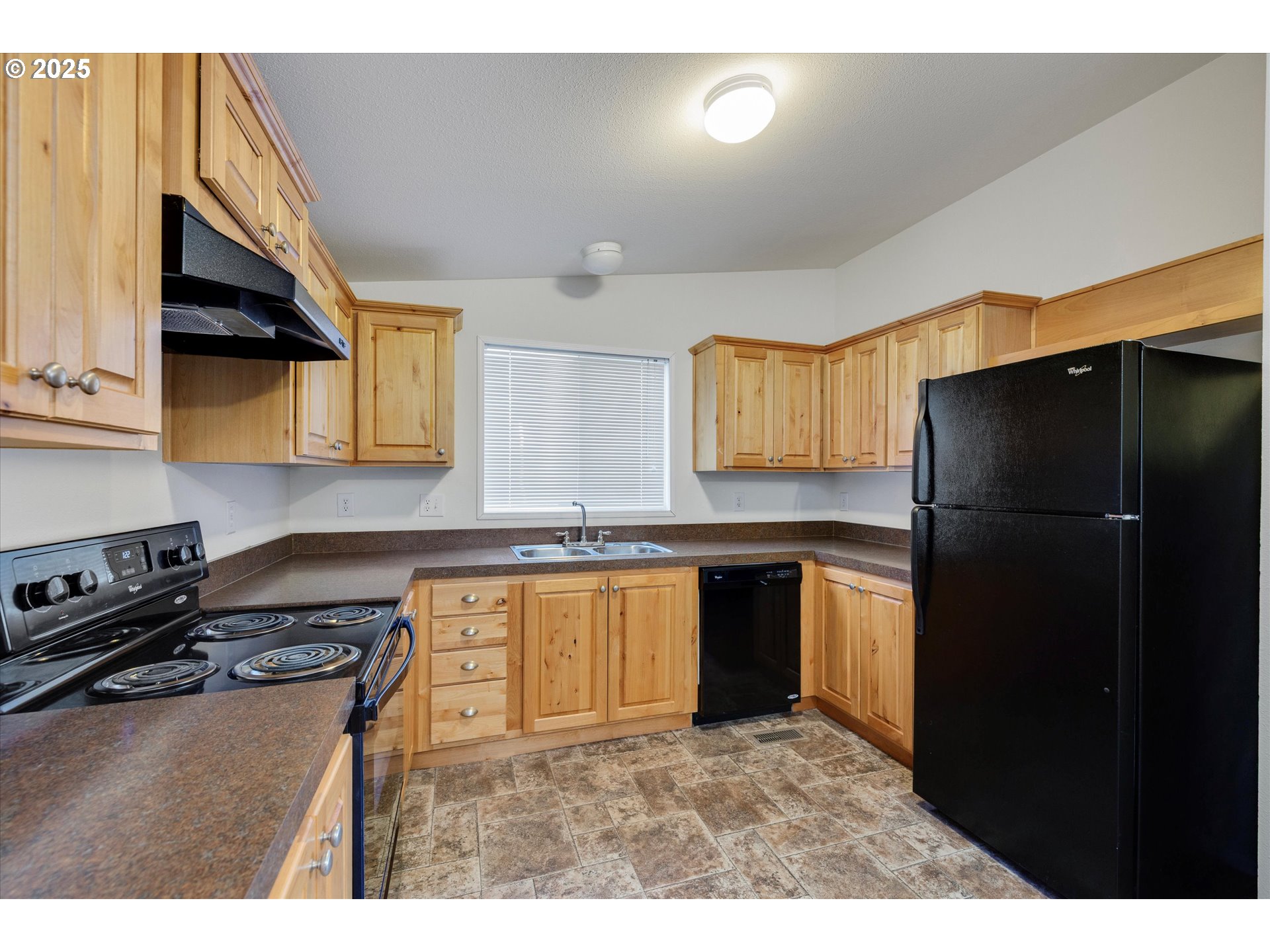 21100 Northeast Sandy Boulevard, Unit 39 Fairview, OR 97024 - Photo 9 of 23 a kitchen with a refrigerator and a stove top oven